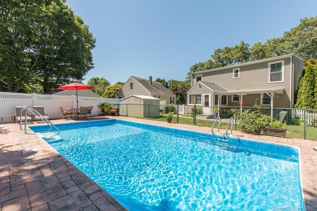 30 Lakeside Road Milford, CT 06460 - Photo 1 of 1 a front view of house with yard and swimming pool