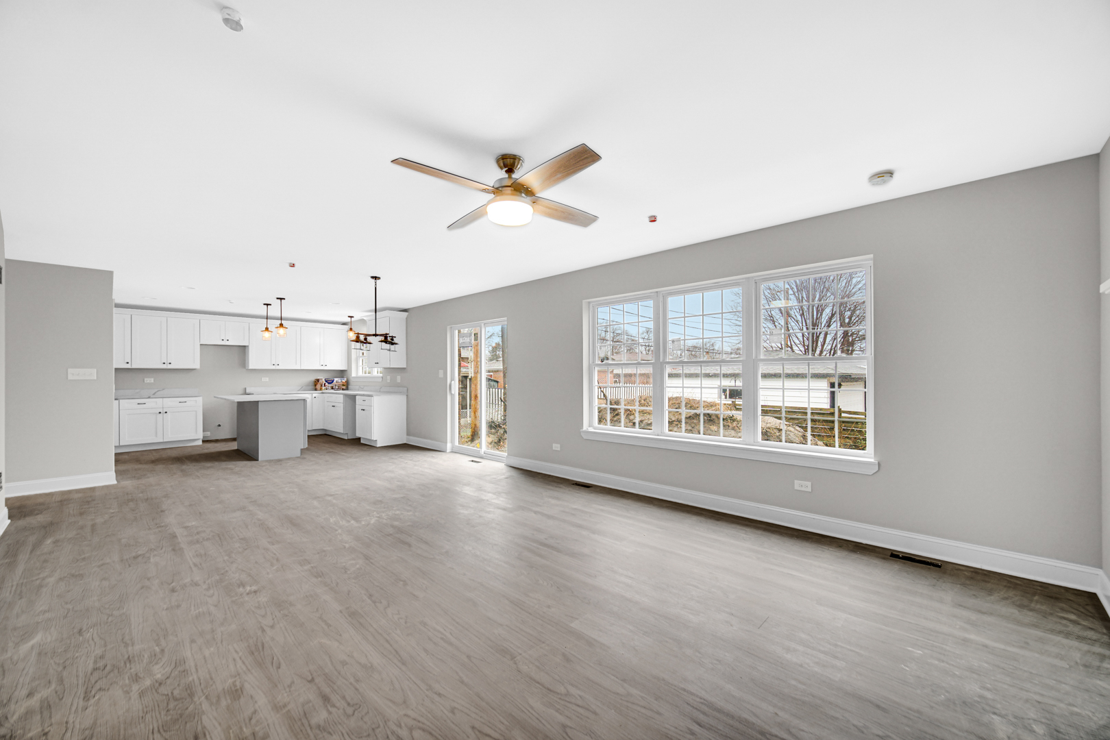 5749 West 109th Street Chicago Ridge, IL 60415 - Photo 10 of 22 a view of a big room with windows and chandelier fan