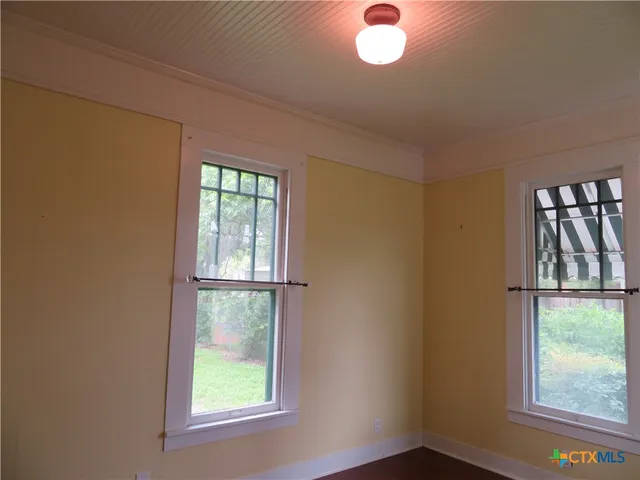a window with white cabinets
