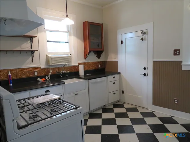 a kitchen with stainless steel appliances a refrigerator and a stove top oven