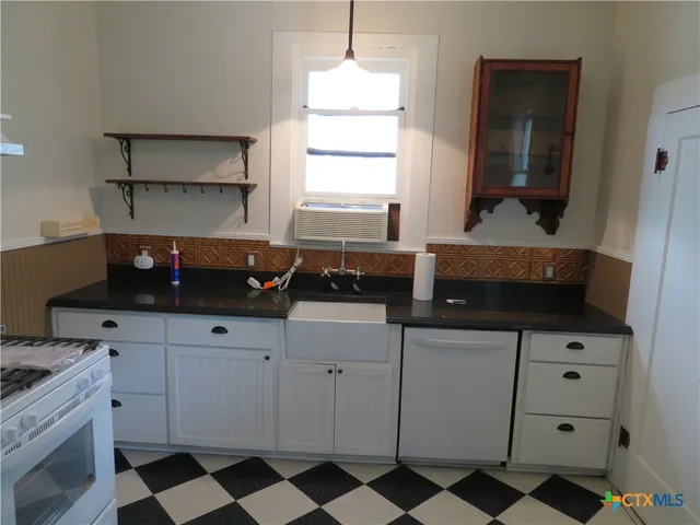 a kitchen with a sink and a stove
