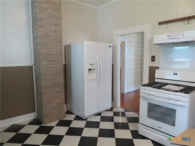 a kitchen with a stove and a refrigerator