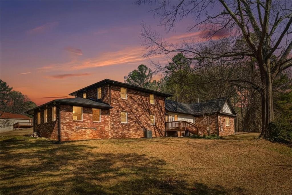 4911 Lower Jersey Road Oxford, GA 30054 - Photo 32 of 56 a front view of a house with a yard and garage