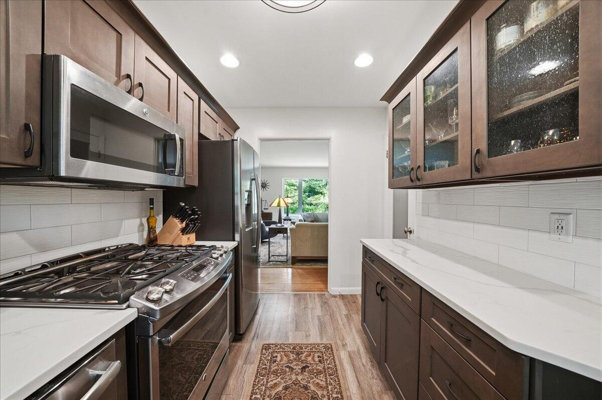 63 Ski Hill Road Portage, IN 46368 - Photo 8 of 28 a kitchen with stainless steel appliances granite countertop a stove and a microwave