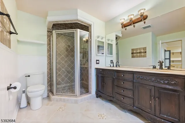 a spacious bathroom with a granite countertop sink toilet and shower