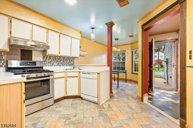 a kitchen with stainless steel appliances granite countertop a stove top oven a sink a counter top space and cabinets