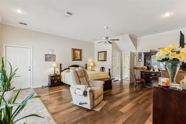 a bathroom with a sink a toilet and a large mirror