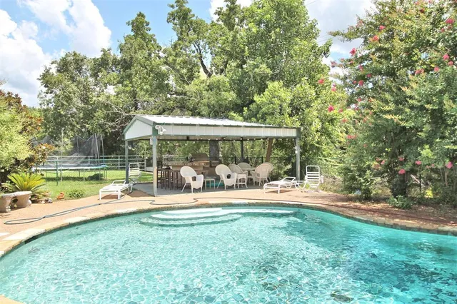 a view of a swimming pool with a yard