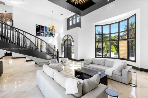 a kitchen with stainless steel appliances granite countertop a sink a stove a refrigerator cabinets and a dining table