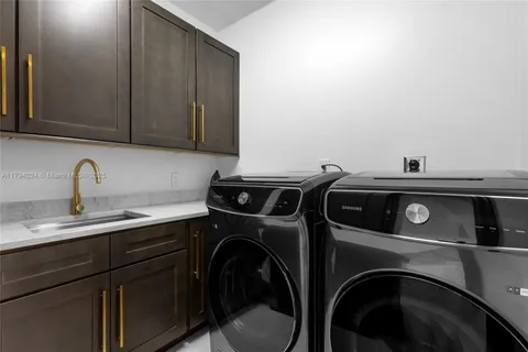 a kitchen with a sink and cabinets