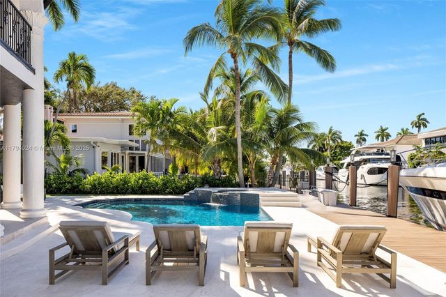 a view of a patio with table and chairs potted plants and palm tree