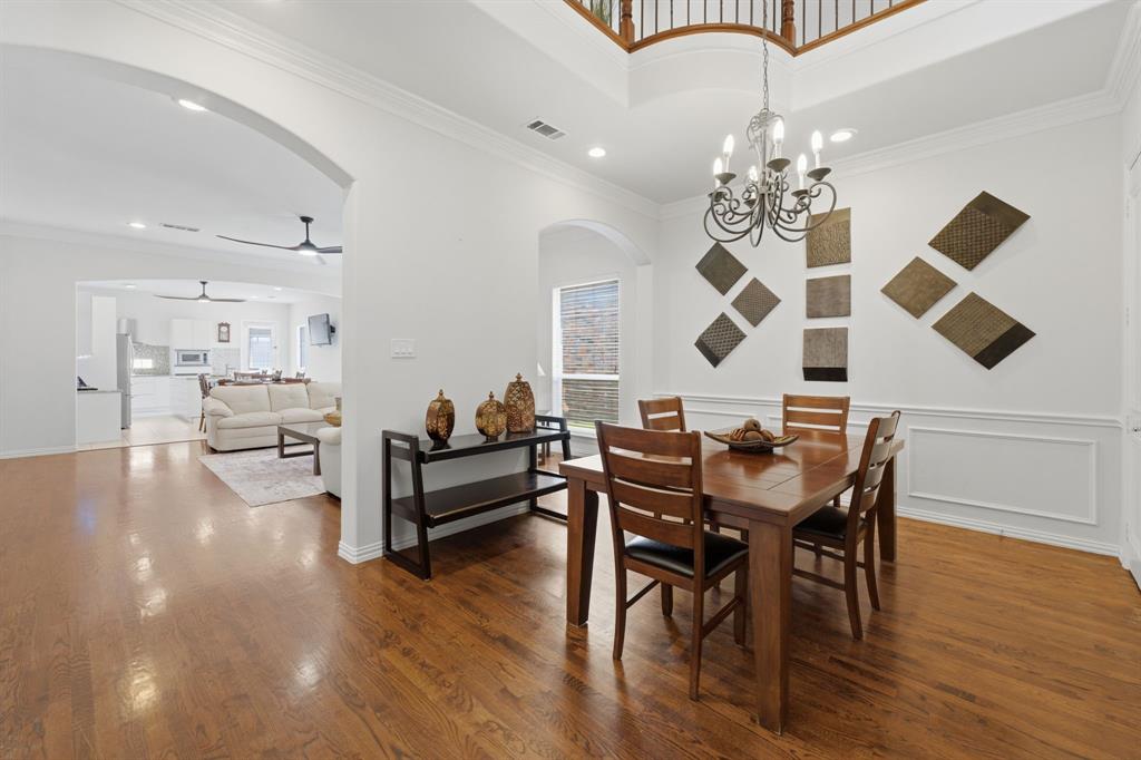 3315 Ricci Lane Irving, TX 75062 - Photo 6 of 40 Hardwood flooring, arched doorway, recessed lighting, chandelier lighting, and a two-story ceiling