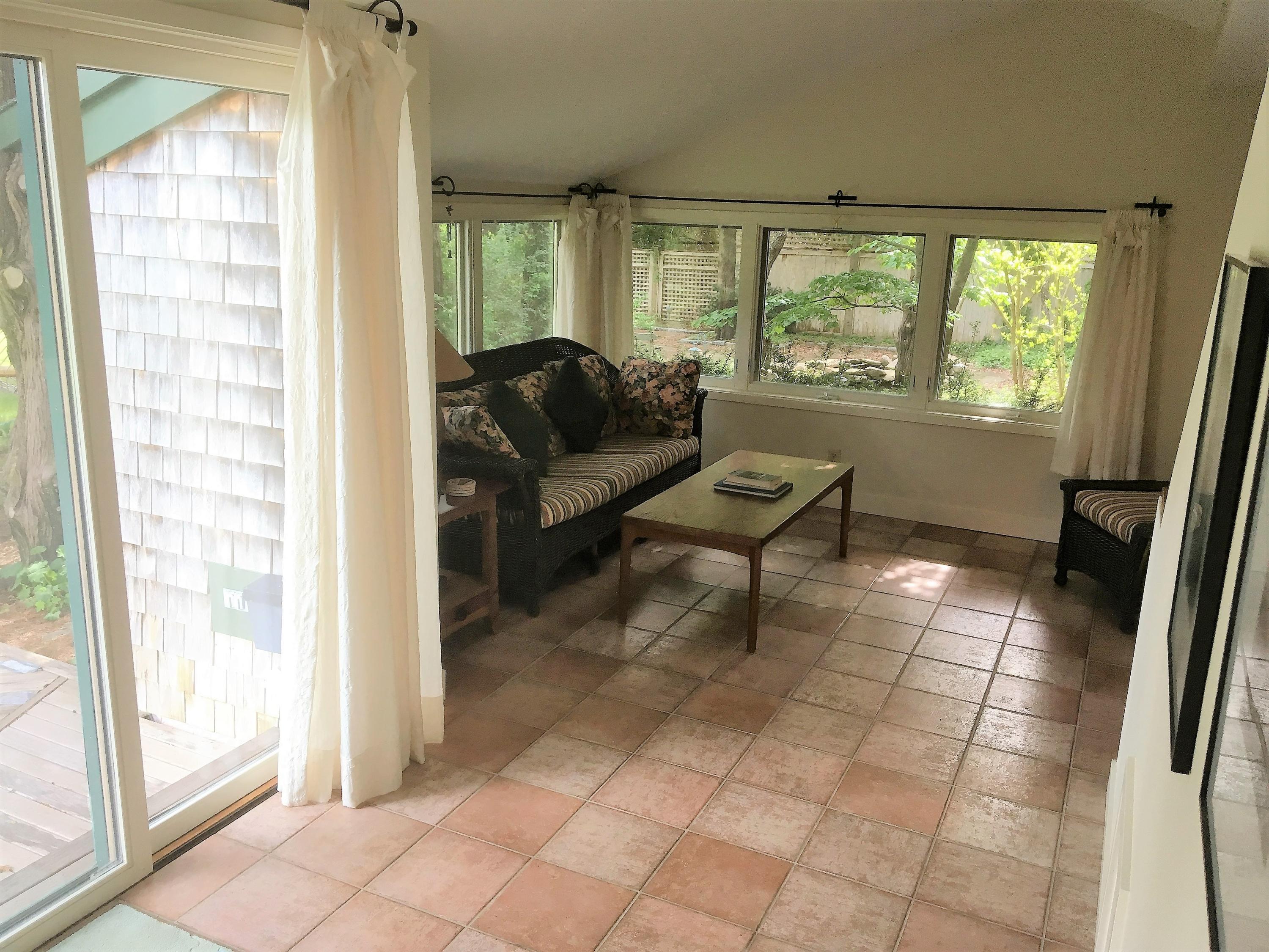 27 Briar Spring Road Orleans, MA 02653 - Photo 11 of 32 a living room with furniture and a large window