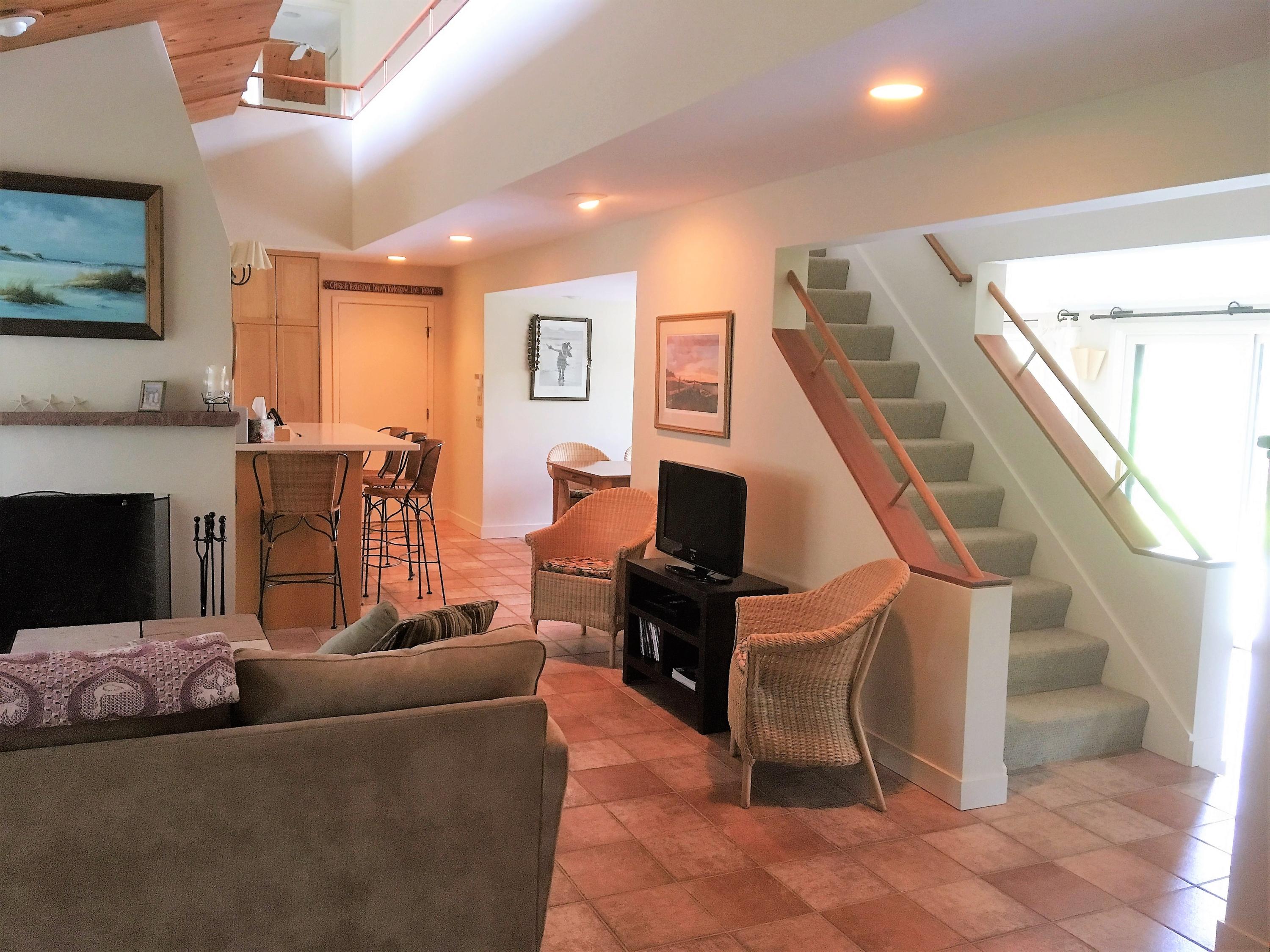 27 Briar Spring Road Orleans, MA 02653 - Photo 12 of 32 a living room with furniture and a fireplace