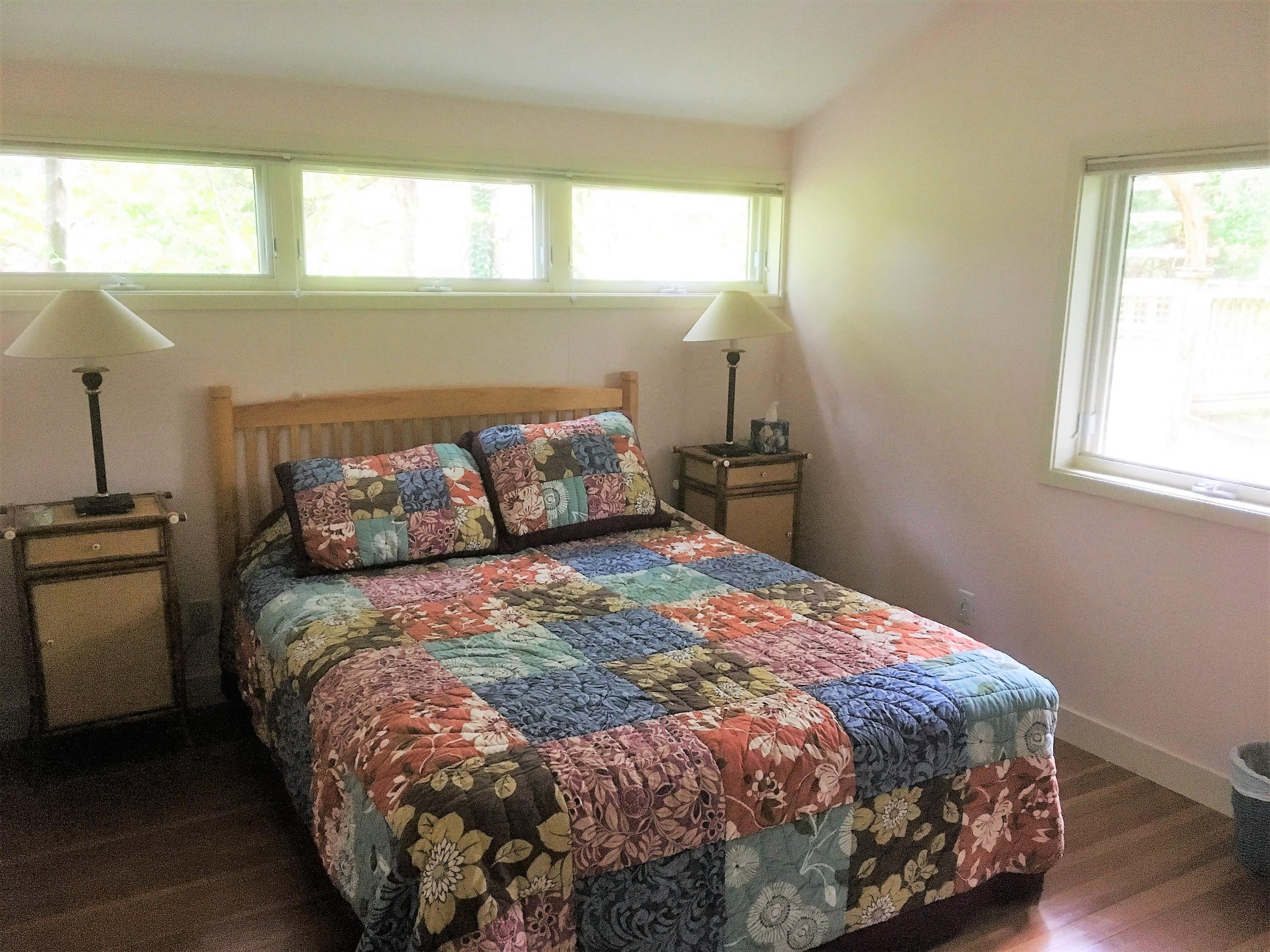 27 Briar Spring Road Orleans, MA 02653 - Photo 17 of 32 a bed sitting in a bedroom next to a window