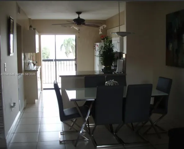 a view of a dining room with furniture and a window