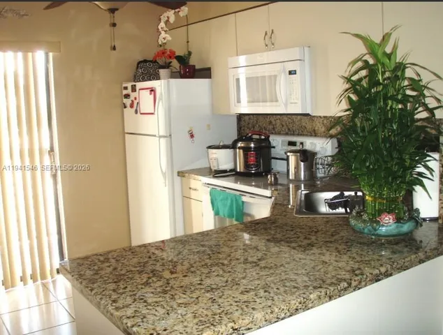 a kitchen with counter top space cabinets and appliances
