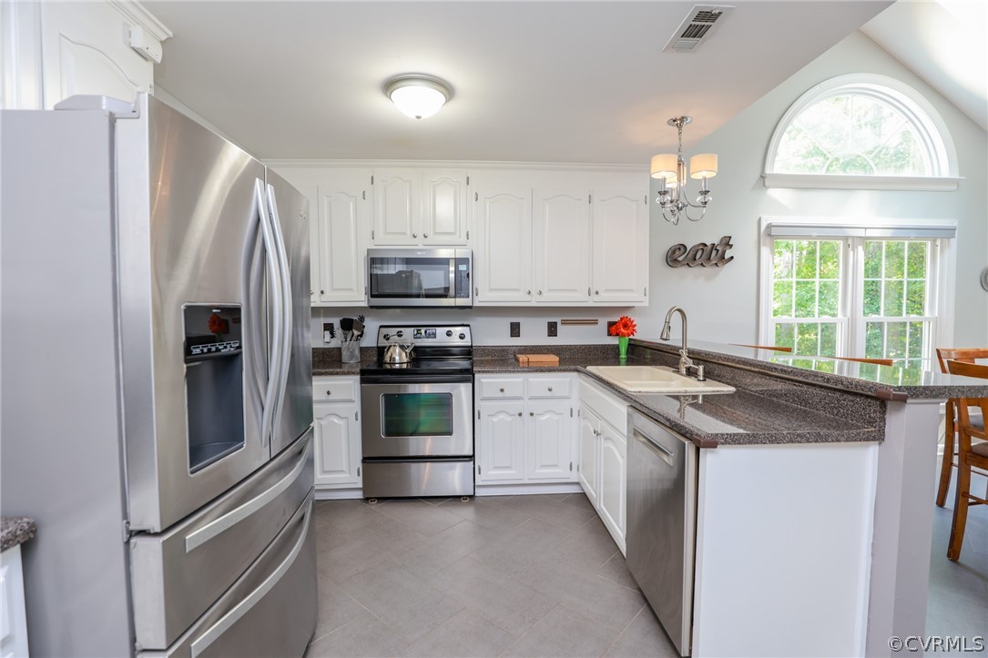 5219 Rock Harbour Road Midlothian, VA 23112 - Photo 16 of 50 a kitchen with stainless steel appliances granite countertop a stove sink and refrigerator