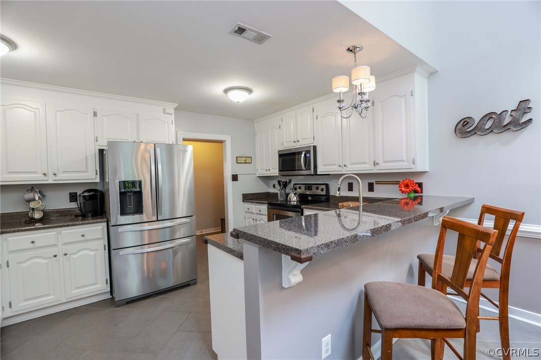 5219 Rock Harbour Road Midlothian, VA 23112 - Photo 17 of 50 a kitchen with stainless steel appliances a microwave a stove and refrigerator