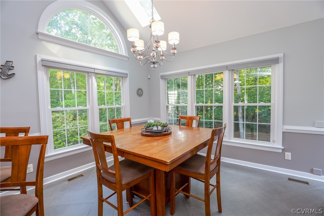 5219 Rock Harbour Road Midlothian, VA 23112 - Photo 19 of 50 a view of a dining room with furniture a chandelier and wooden floor
