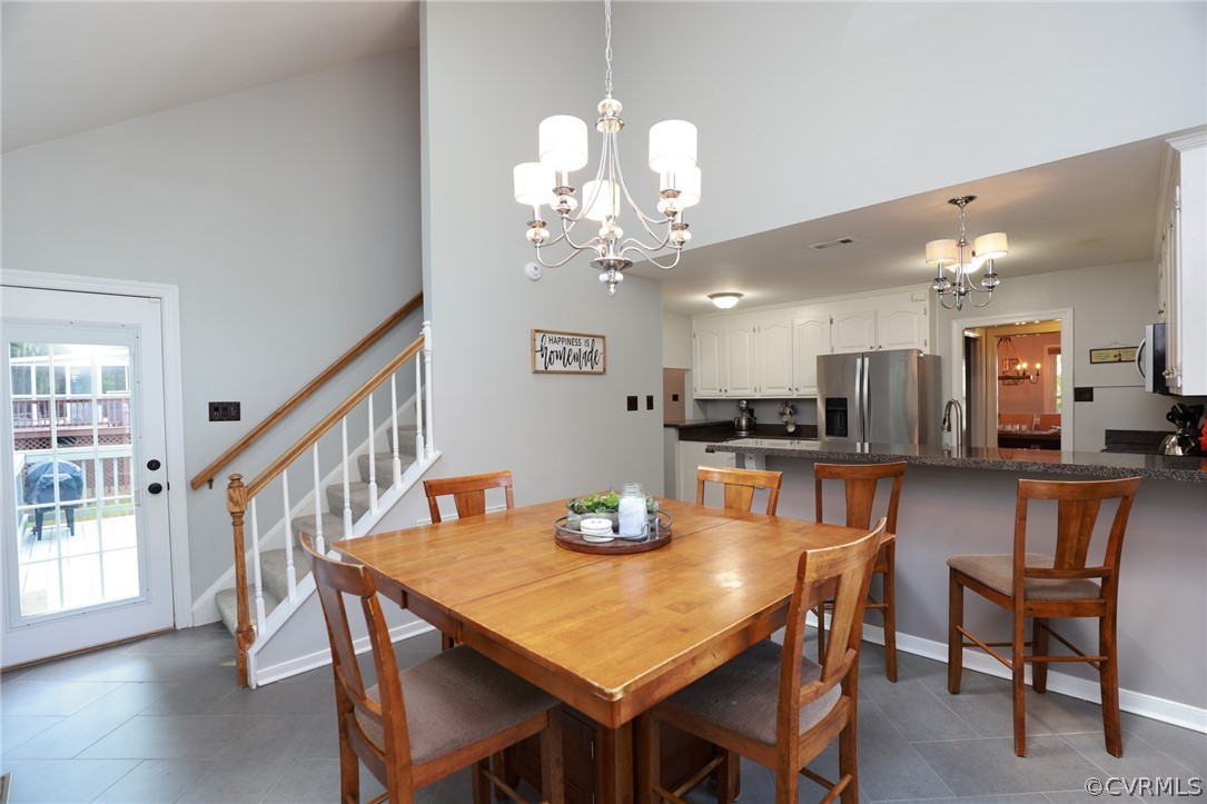 5219 Rock Harbour Road Midlothian, VA 23112 - Photo 20 of 50 a view of a dining room with furniture and a chandelier