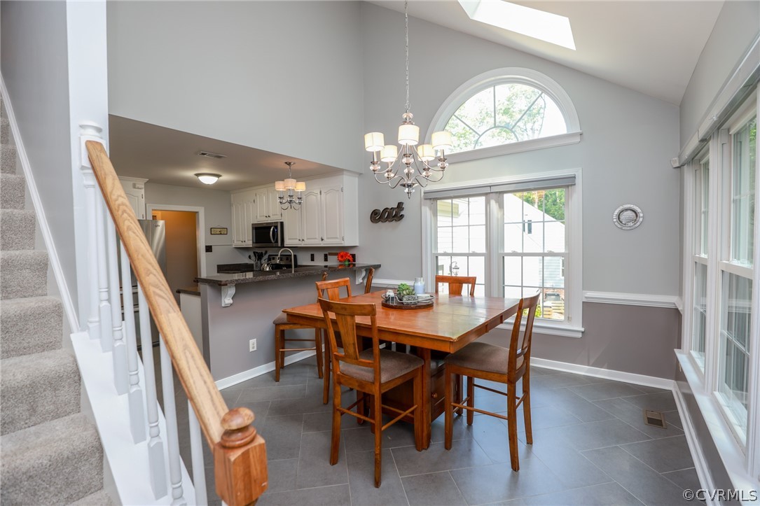 5219 Rock Harbour Road Midlothian, VA 23112 - Photo 21 of 50 a dining room with furniture a chandelier and wooden floor