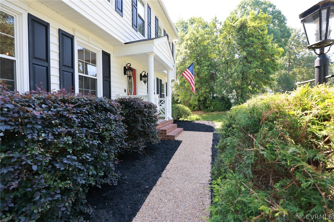 5219 Rock Harbour Road Midlothian, VA 23112 - Photo 3 of 50 a view of a pathway with flower plants and flower plants
