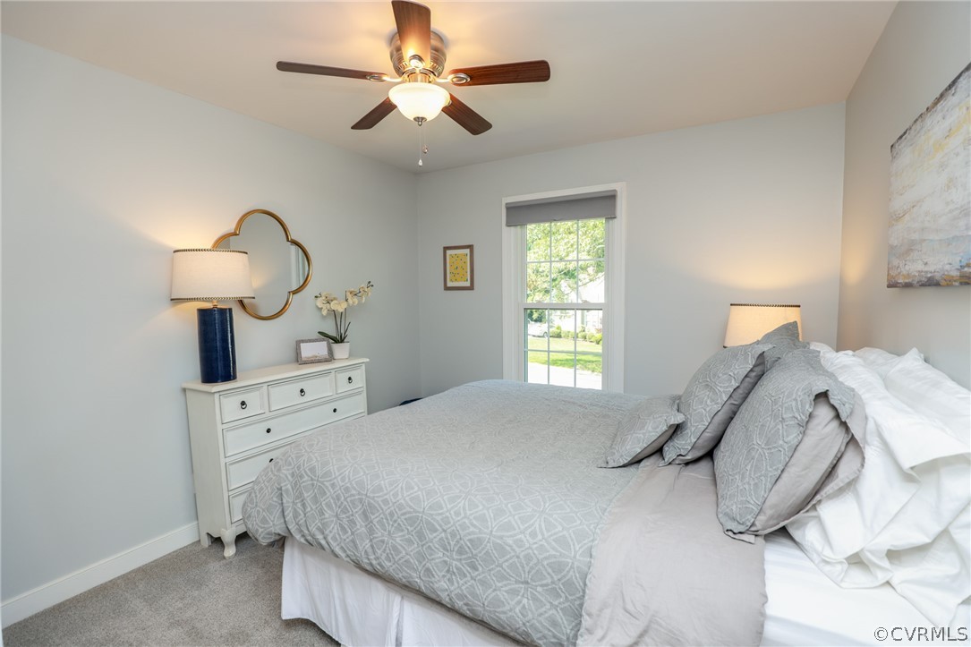 5219 Rock Harbour Road Midlothian, VA 23112 - Photo 31 of 50 a bedroom with a bed and a chandelier