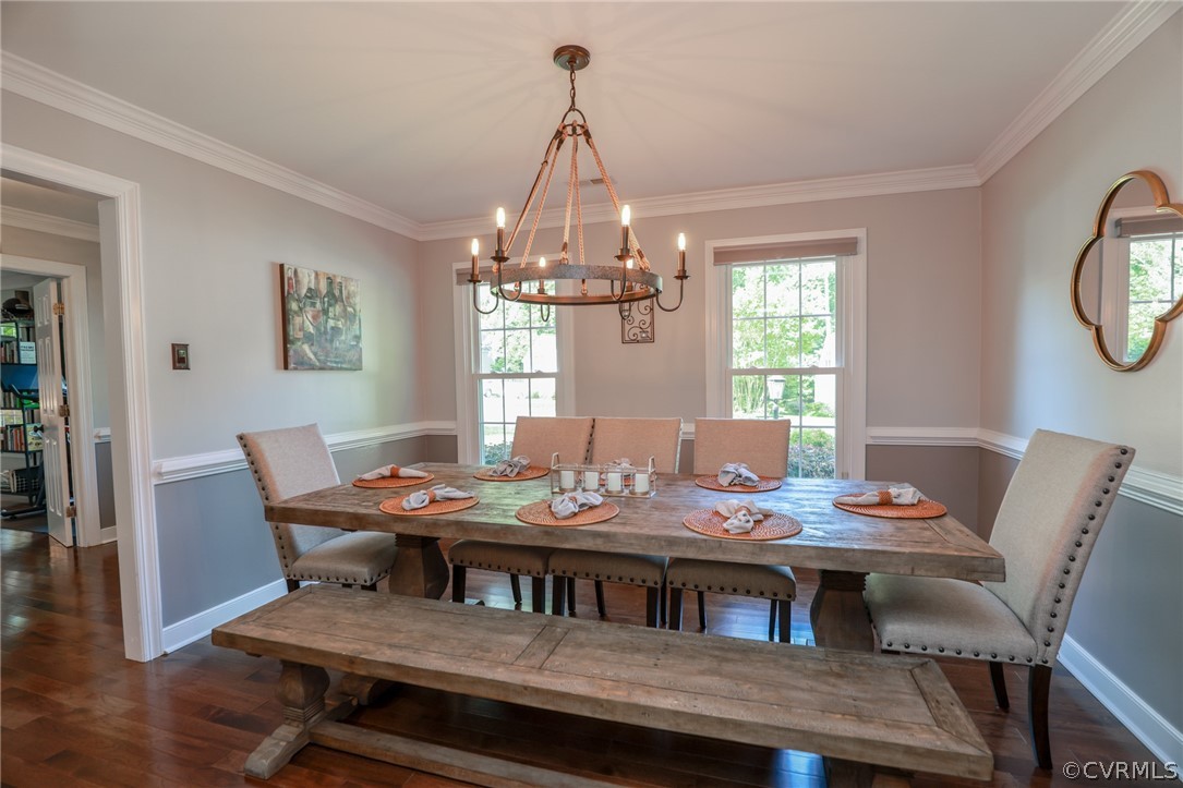 5219 Rock Harbour Road Midlothian, VA 23112 - Photo 7 of 50 a dining room with furniture a chandelier and wooden floor