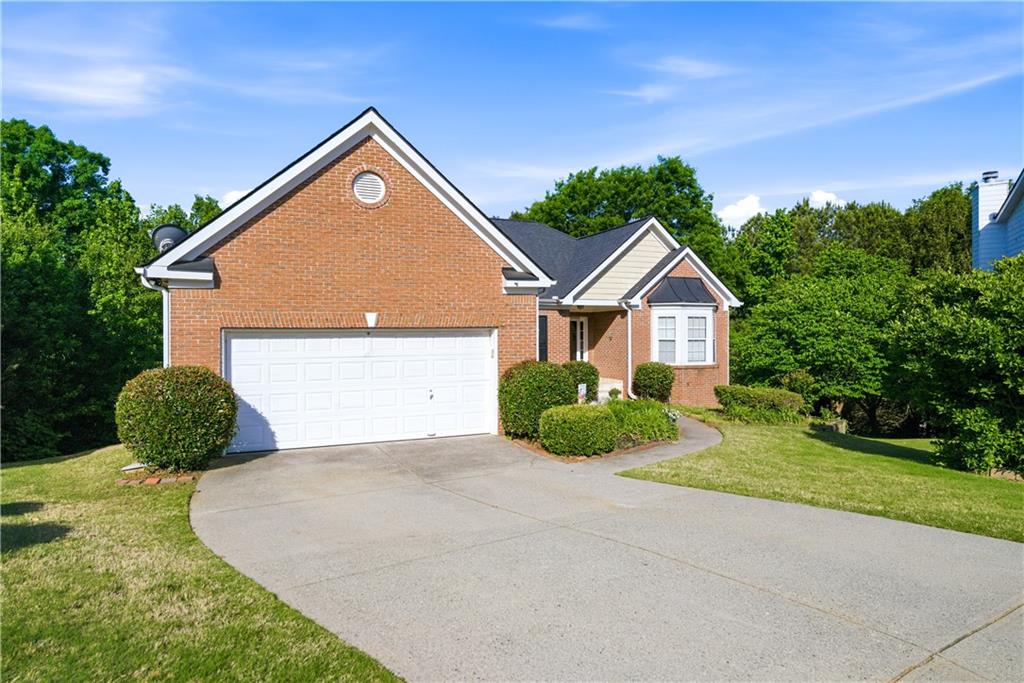 3324 Dunbar Lane Suwanee, GA 30024 - Photo 1 of 42 a front view of a house with a yard and garage
