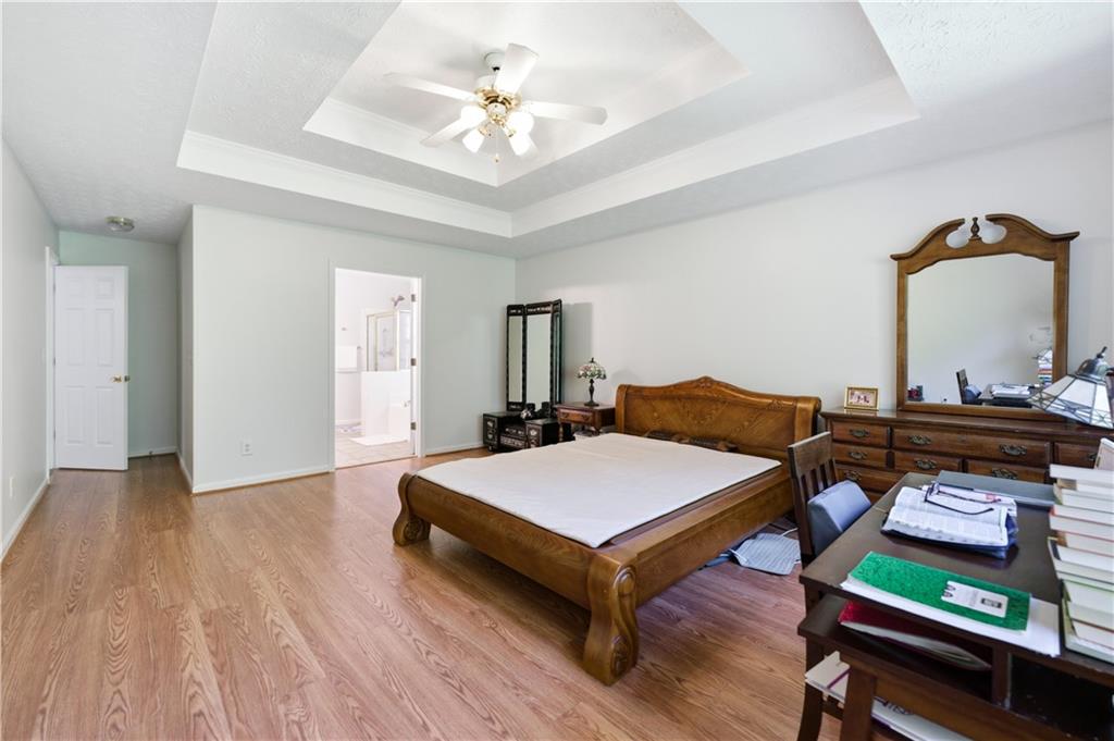 3324 Dunbar Lane Suwanee, GA 30024 - Photo 16 of 42 a bed room with a bed and paintings on the wall