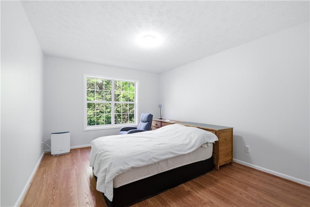 3324 Dunbar Lane Suwanee, GA 30024 - Photo 19 of 42 a large bed sitting in a bedroom next to a window