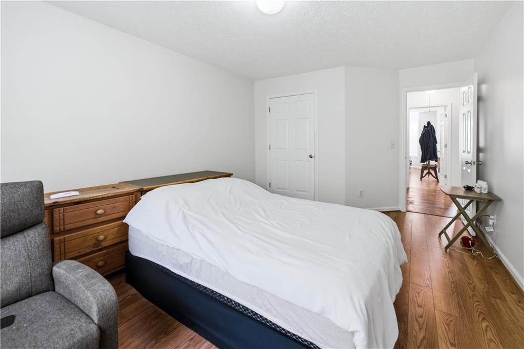 3324 Dunbar Lane Suwanee, GA 30024 - Photo 20 of 42 a bed room with a bed and a chair