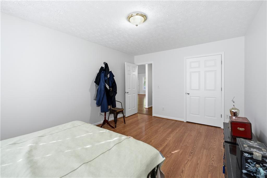 3324 Dunbar Lane Suwanee, GA 30024 - Photo 23 of 42 a bed room with a bed and a chandelier
