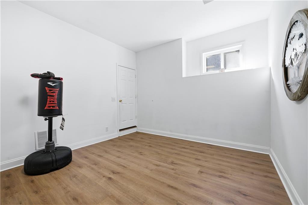 3324 Dunbar Lane Suwanee, GA 30024 - Photo 25 of 42 a view of empty room with a window and wooden floor