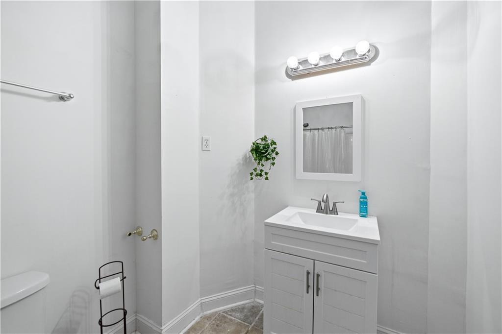 3324 Dunbar Lane Suwanee, GA 30024 - Photo 33 of 42 a bathroom with a sink toilet and mirror