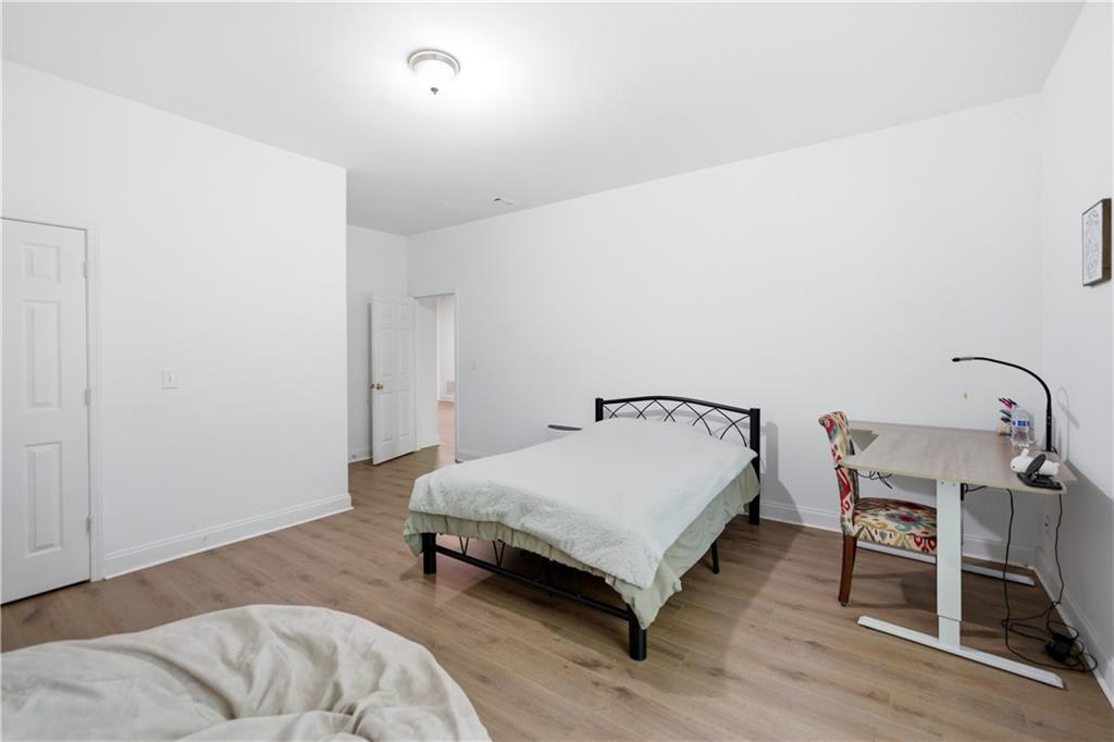 3324 Dunbar Lane Suwanee, GA 30024 - Photo 36 of 42 a spacious bedroom with a bed and a chair