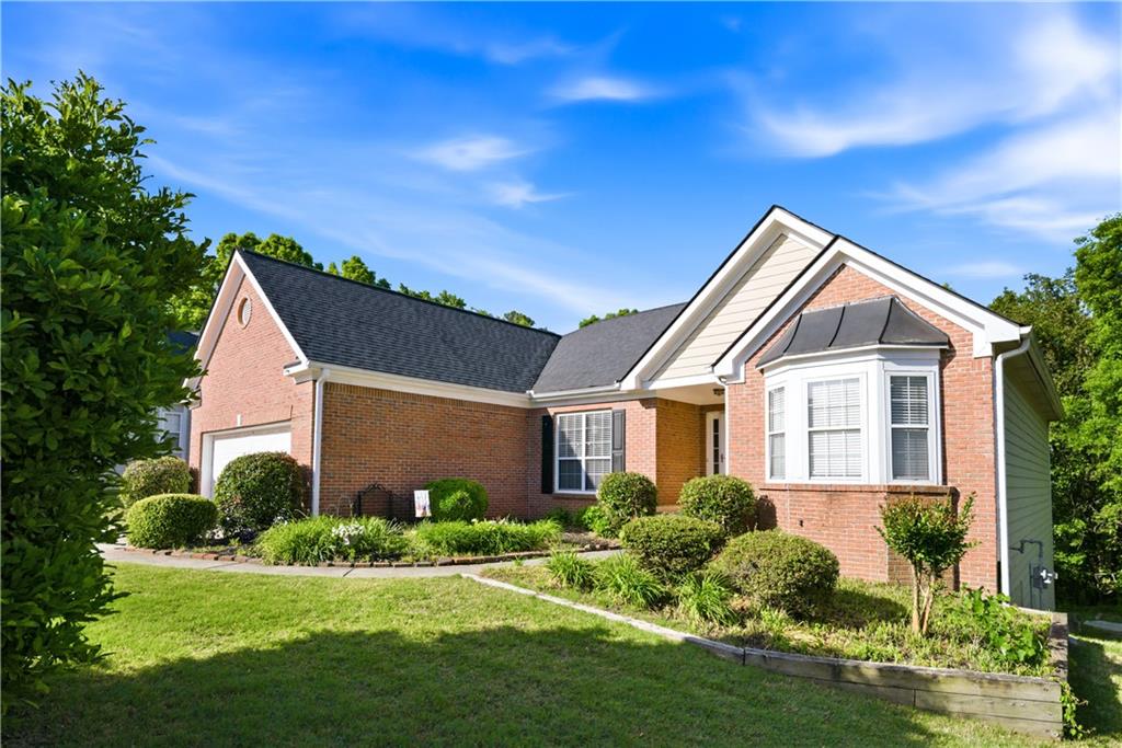 3324 Dunbar Lane Suwanee, GA 30024 - Photo 42 of 42 a front view of a house with a yard