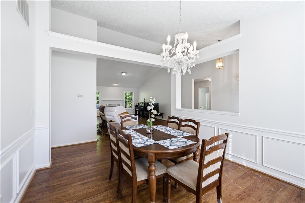 3324 Dunbar Lane Suwanee, GA 30024 - Photo 6 of 42 a view of a dining room with furniture and chandelier