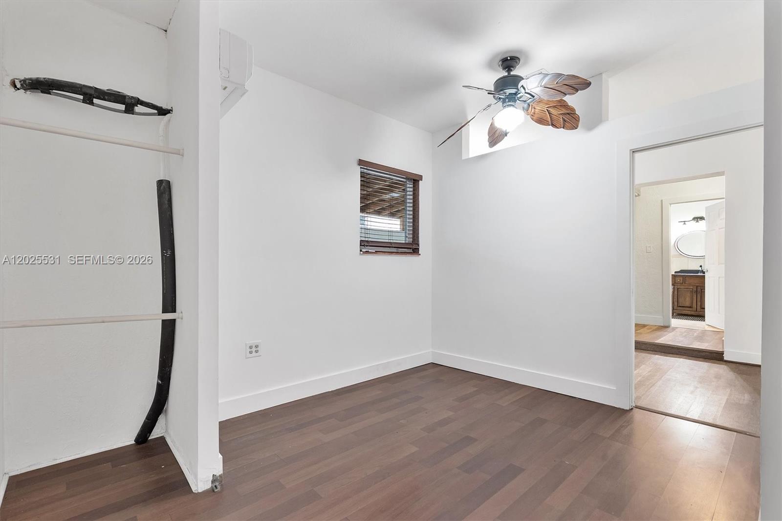 3951 Southwest 2nd Terrace, Unit 3951 Miami, FL 33134 - Photo 17 of 21 wooden floor in an empty room with a window