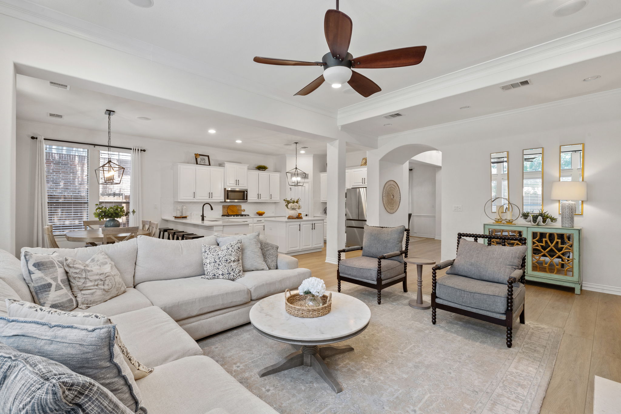 1124 Castle Path Round Rock, TX 78681 - Photo 12 of 40 An inviting open-concept living area boasts a modern kitchen and sunlit dining nook.