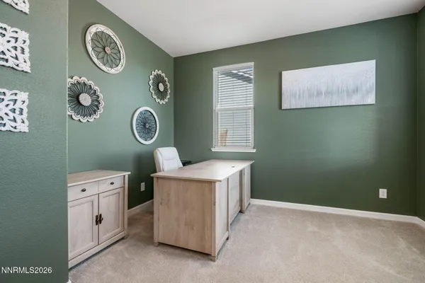a room with a stove a clock and a window