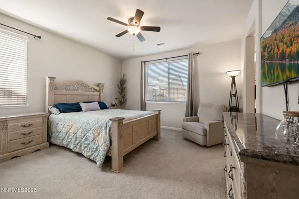 a bedroom with a bed a couch and dresser