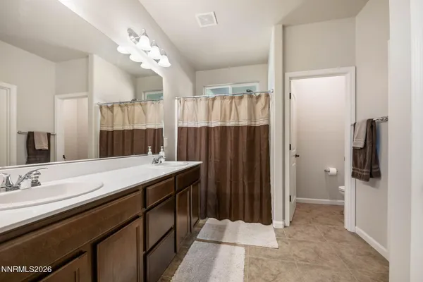 a bathroom with a double vanity sink and mirror
