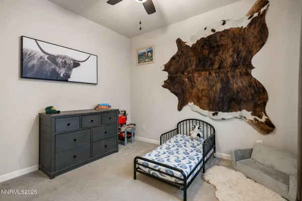 a bedroom with a bed and a painting on the wall