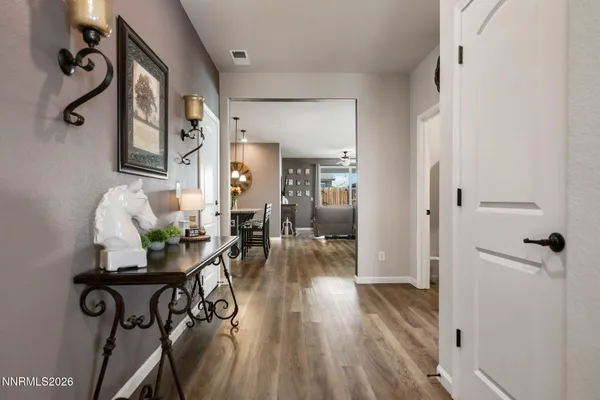a view of a livingroom with furniture and hardwood floor