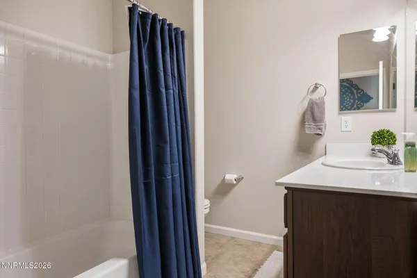 a view of storage and utility room with closet and a window