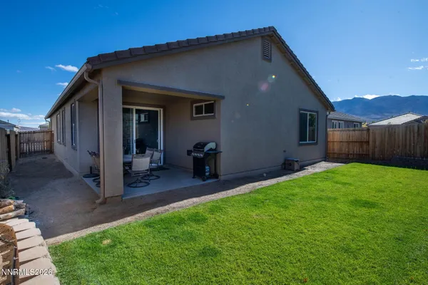 a view of a backyard with wooden fence
