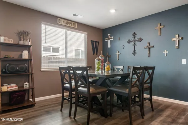 a view of a dining room with furniture and wooden floor