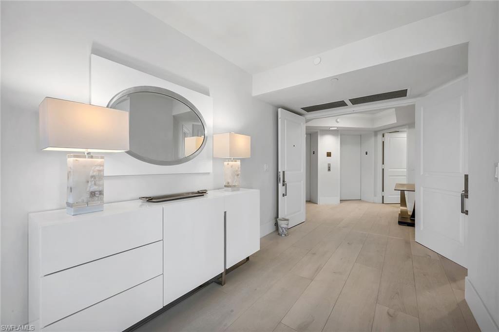 6597 Nicholas Boulevard, Unit 401 Naples, FL 34108 - Photo 16 of 28 a spacious bathroom with a sink and a mirror